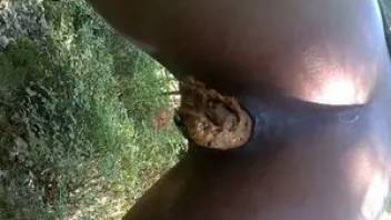 Black girl pooping in nature