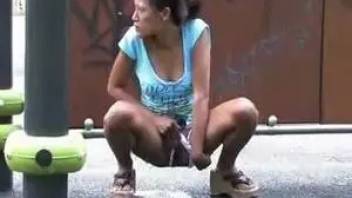 Woman pissing in the street