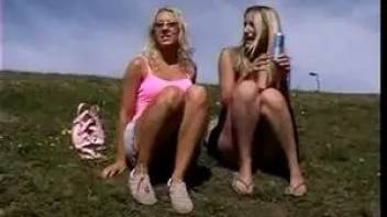 Two blondes pissing on the hill